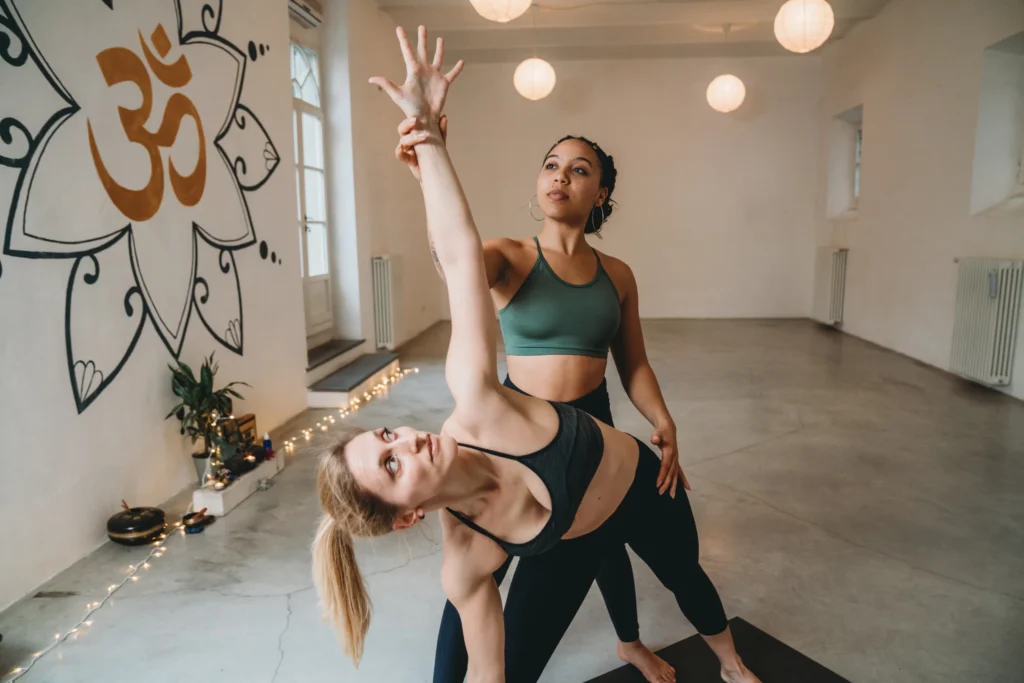 yoga studio instructor with a student