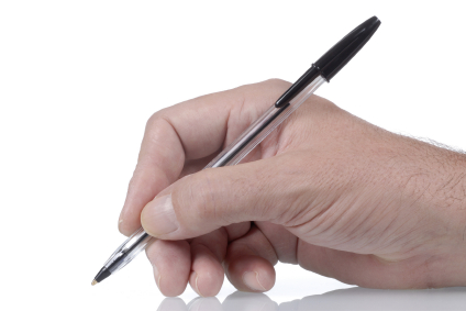 Ordinary black ballpoint pen in male hand