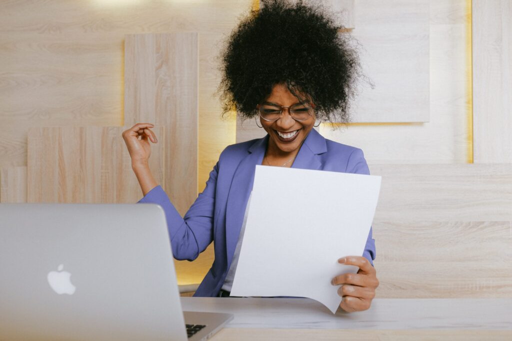 woman cheering after reviewing what worked and what didn't