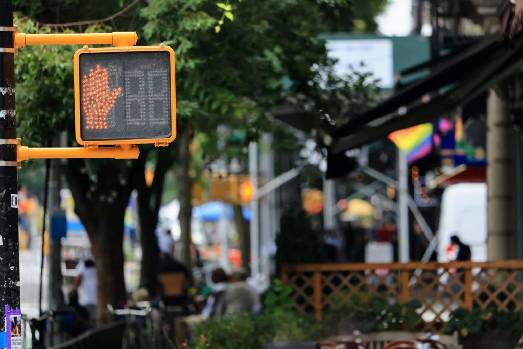 A stop sign next to a restaurant garden in Harlem NYC neighborhoods
