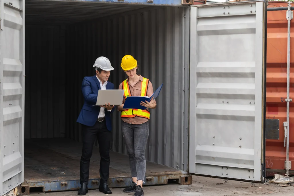 man in hard hats in a trailer supply chain freight broker