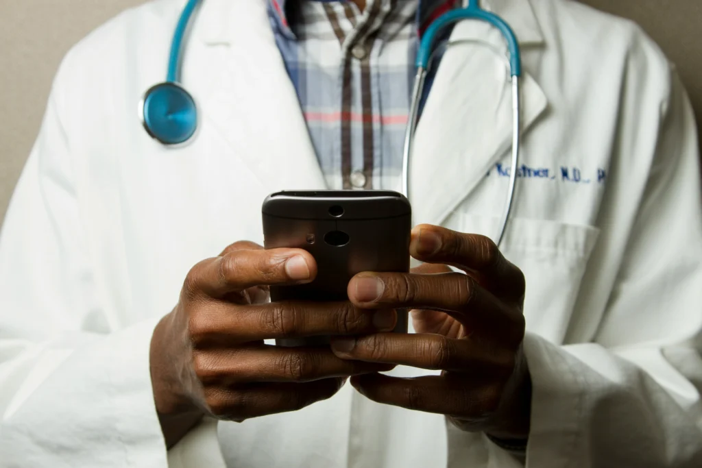 doctor reviewing patient data on mobile phone