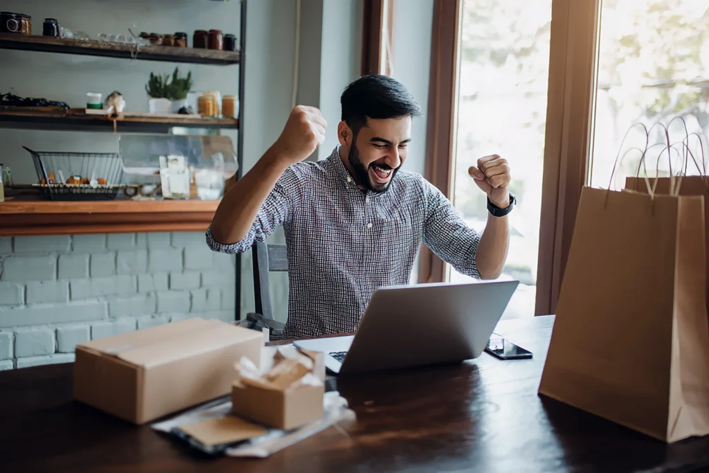 Excited person celebrating online success.