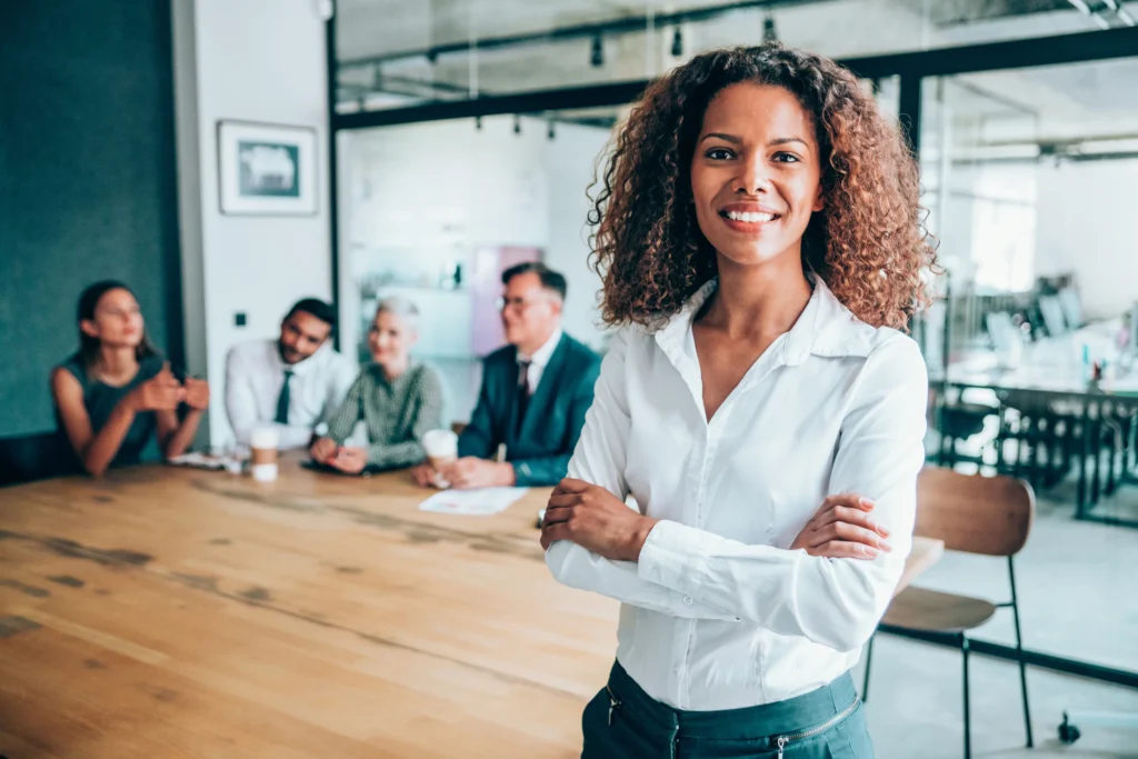 business success: Confident and successful woman entrepreneur in a meeting room.