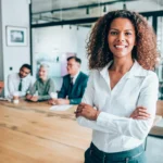 business success: Confident and successful woman entrepreneur in a meeting room.