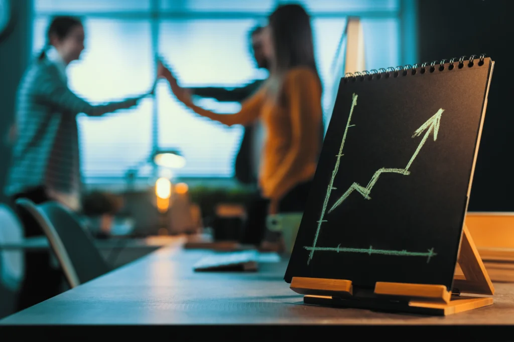 Team collaboration with growth chart indicating business success.
