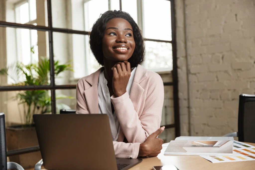 Woman in office, smiling at her success
