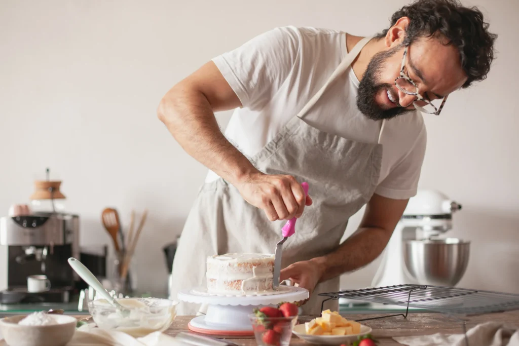 start a food business: man baking a cake