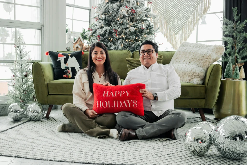 holiday readiness: couple with a Happy Holiday pillow